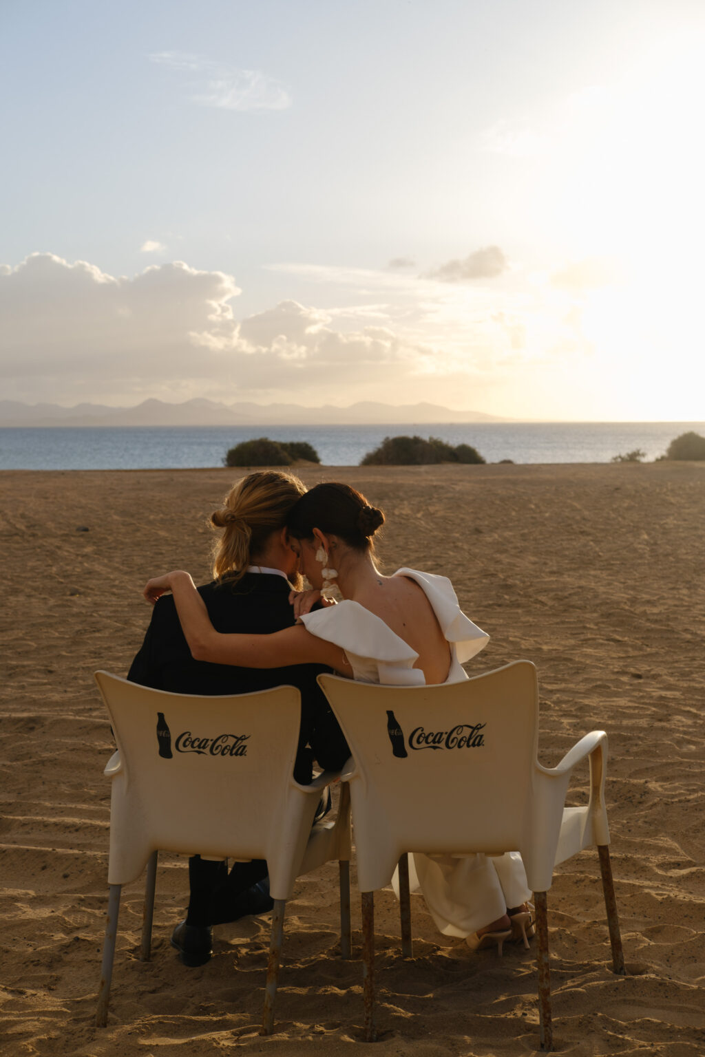bride and groom seated looking at the sea view